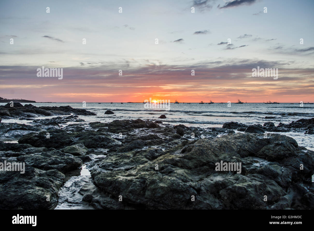 Sunset seascape and rocks, Tamarindo beach,  Guanacaste, Costa Rica Stock Photo