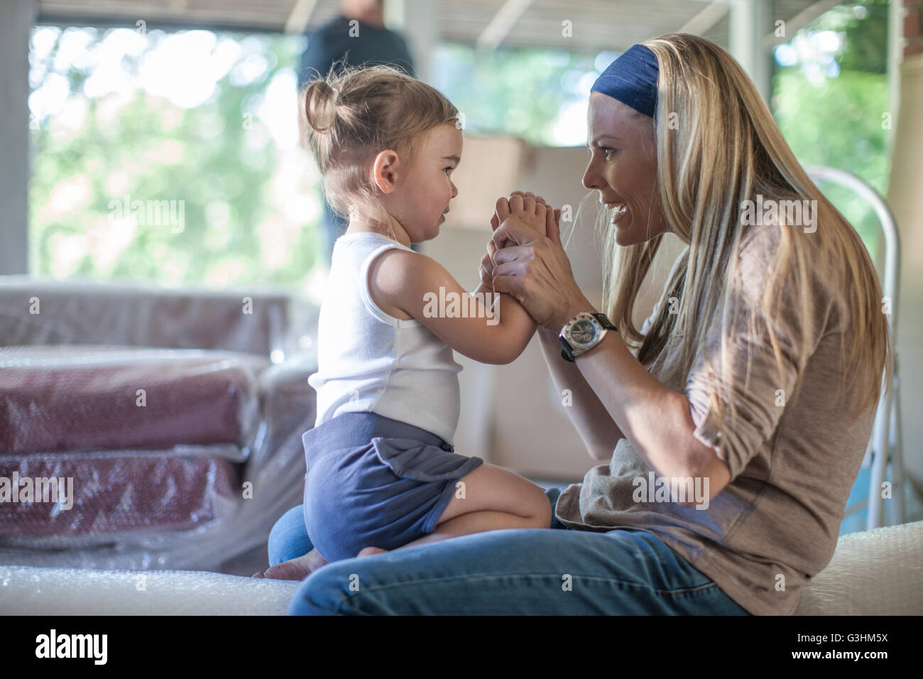 Moving house mother and daughter sitting together Stock Photo Alamy