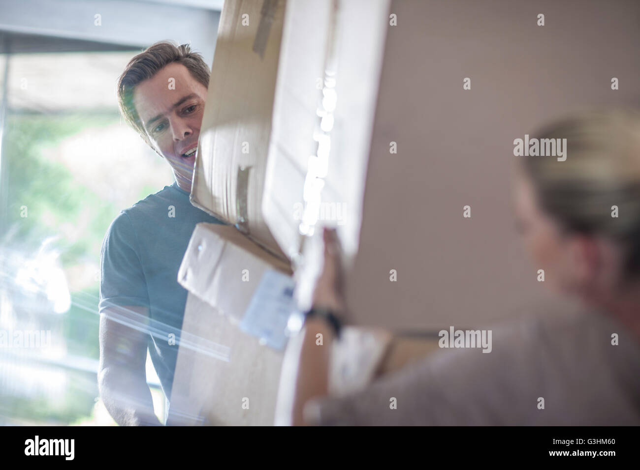 Woman lifting mature boxes hi-res stock photography and images - Alamy