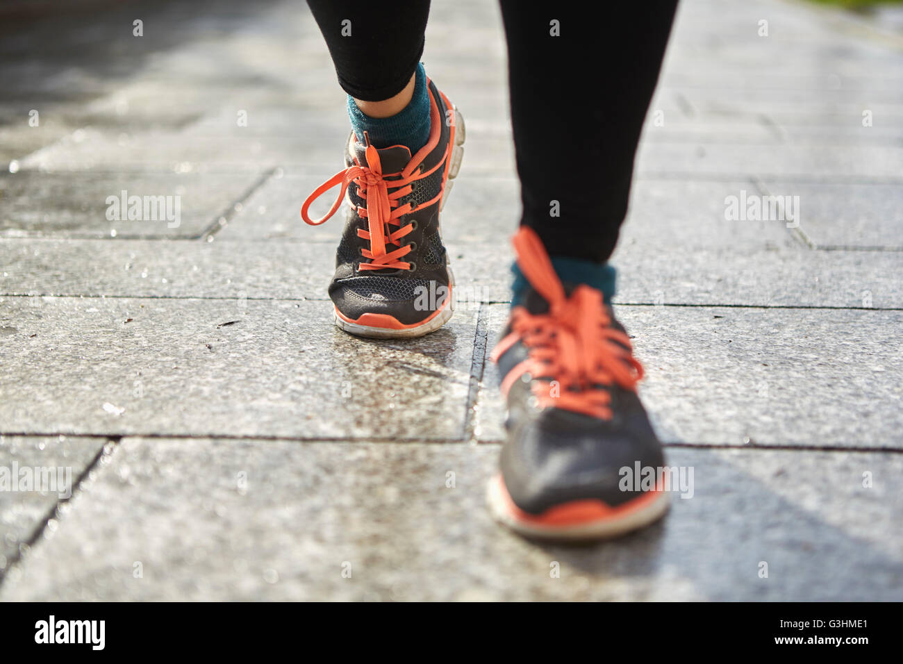 Legs of woman wearing running shoes on pavement Stock Photo Alamy