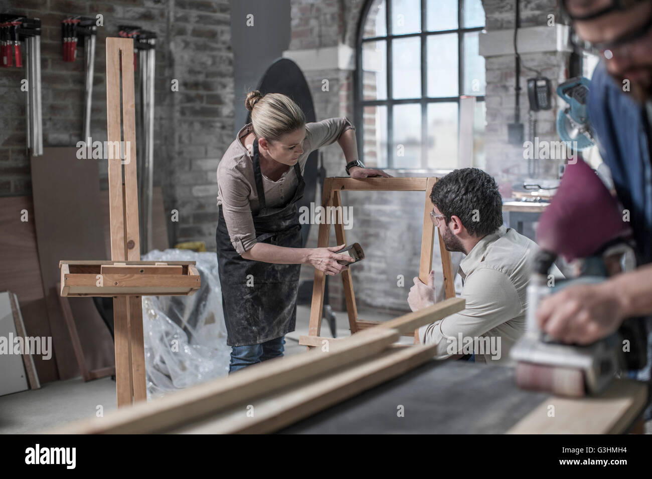 Carpenter team sanding wood in antique restoration workshop Stock Photo ...