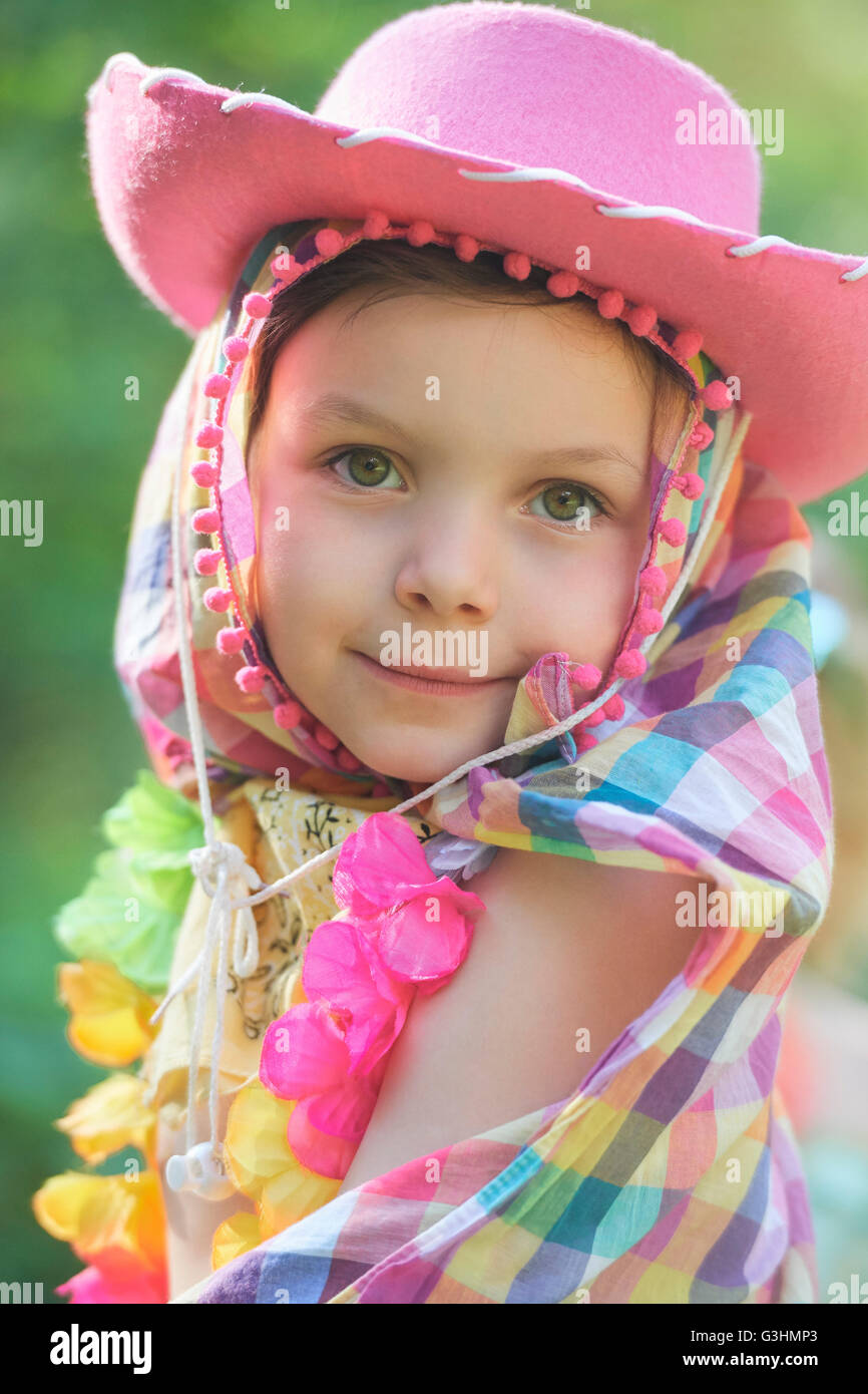 Portrait of girl wearing pink cowboy hat in garden Stock Photo