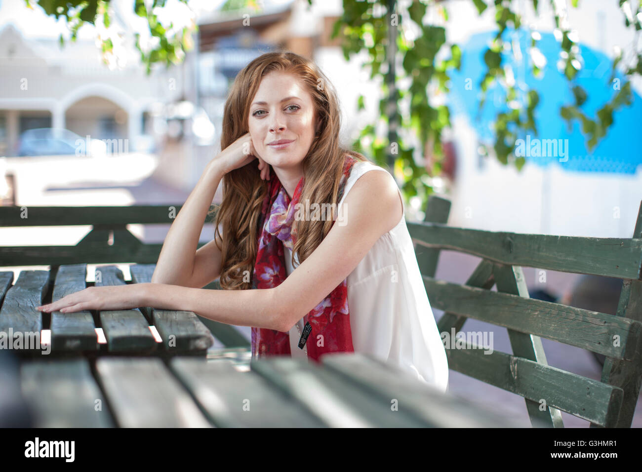 Portrait of young woman in city at sidewalk cafe Stock Photo - Alamy