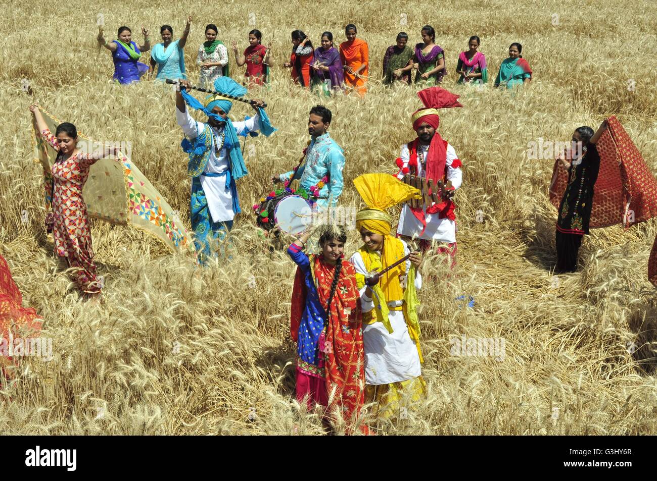 College students perform the 'Bhangra', a Punjabi folk dance, in a filed of Wheat on the eve of Vaisakhi at village Baran, Sirhind road. Vaisakhi is the festival of the first harvest of the year right after the winter season. (Photo by Rajesh Sachar / Pacific Press) Stock Photo