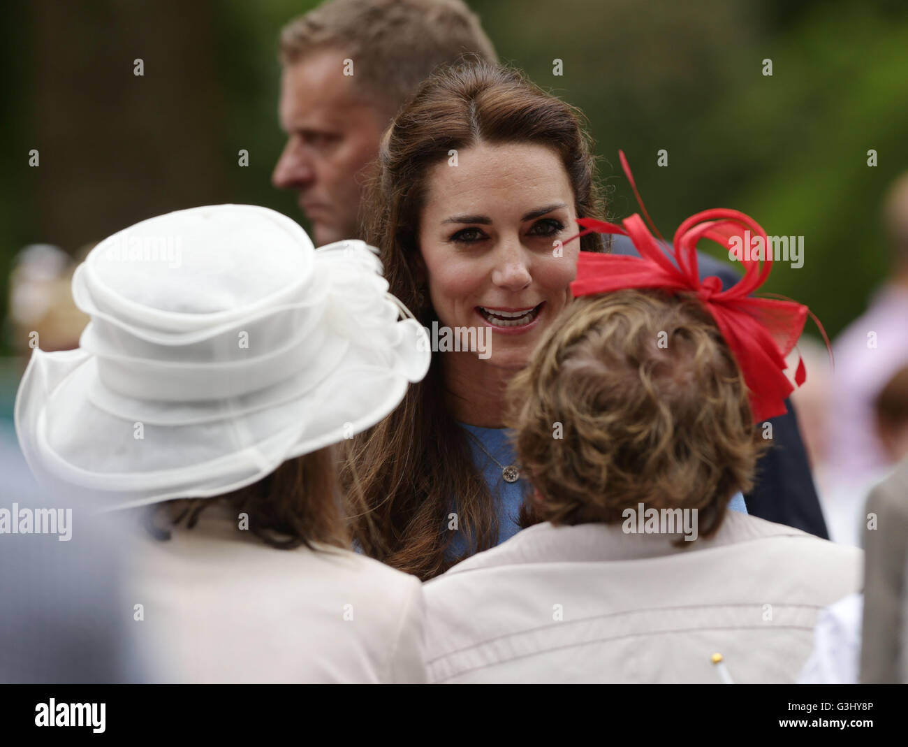 The Duchess of Cambridge meeting revellers as she makes their way down The Mall during the Patron's Lunch in central London in honour of the Queen's 90th birthday. Stock Photo