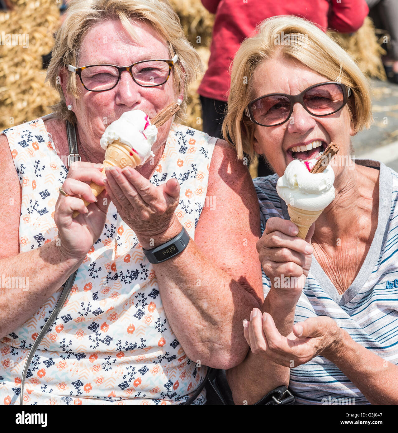Two ladies enjoy their icecream during a Spring Gala Parade Stock