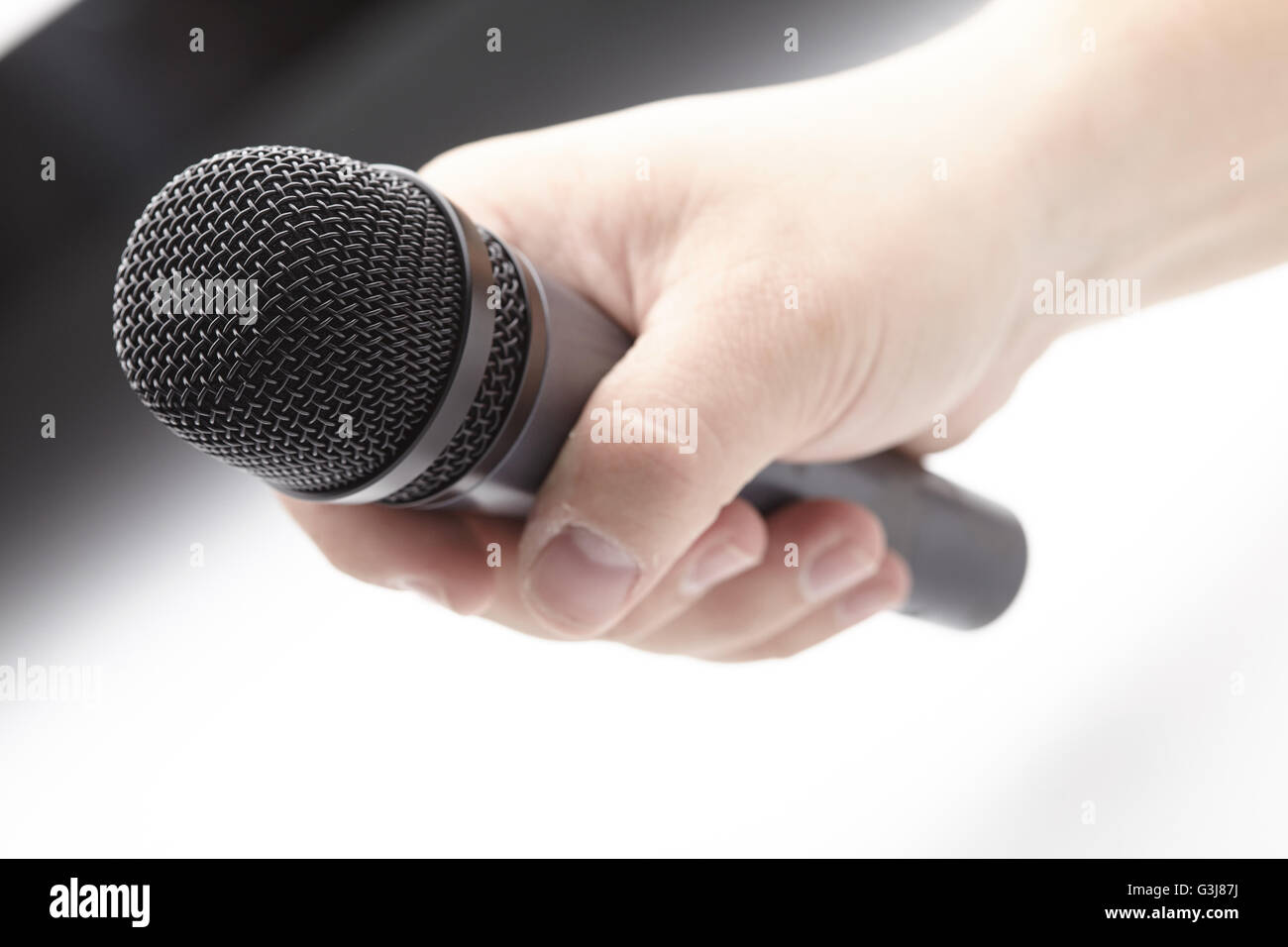 Microphone in a man's hand Stock Photo - Alamy