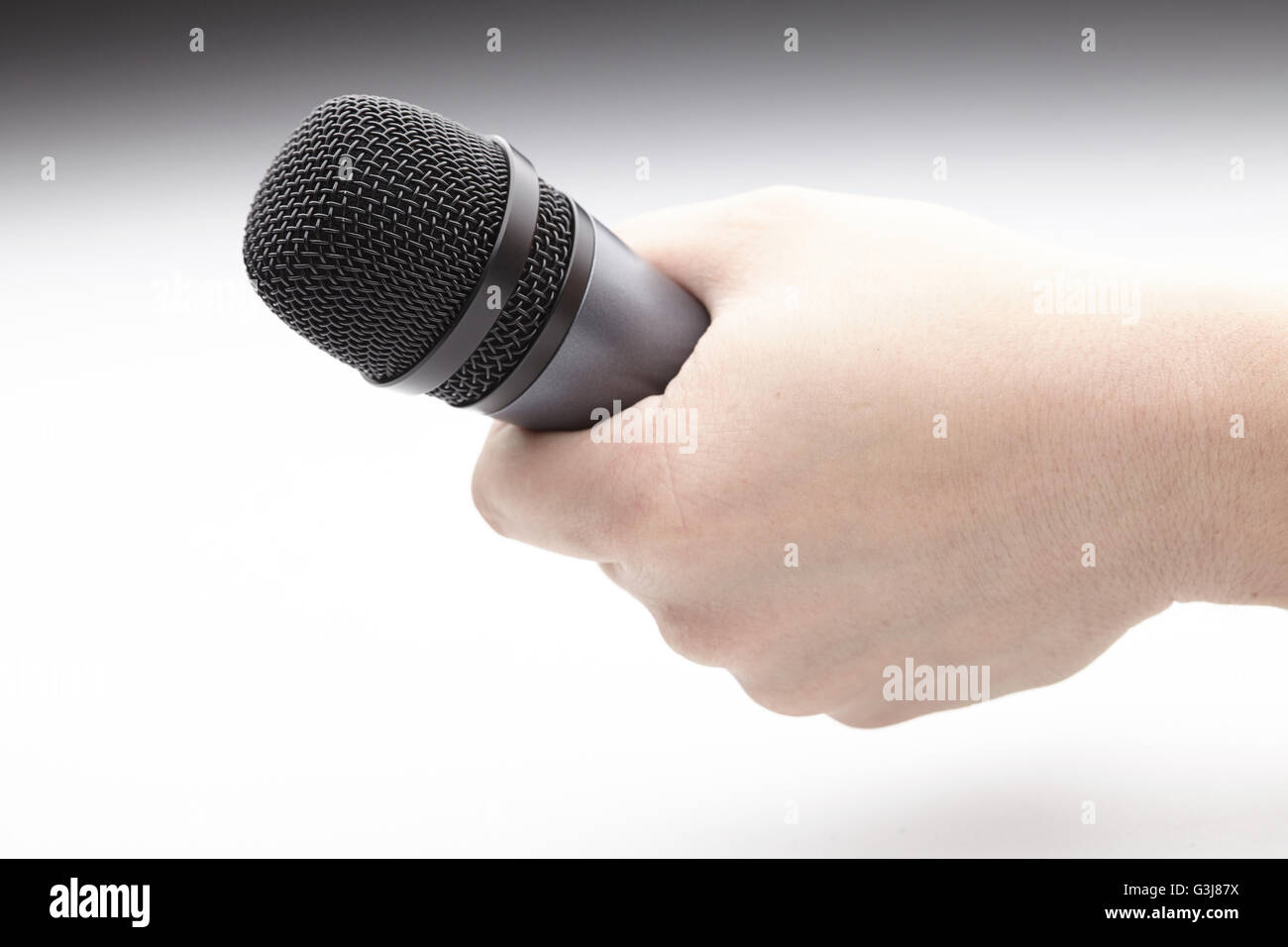 Microphone in a man's hand Stock Photo - Alamy