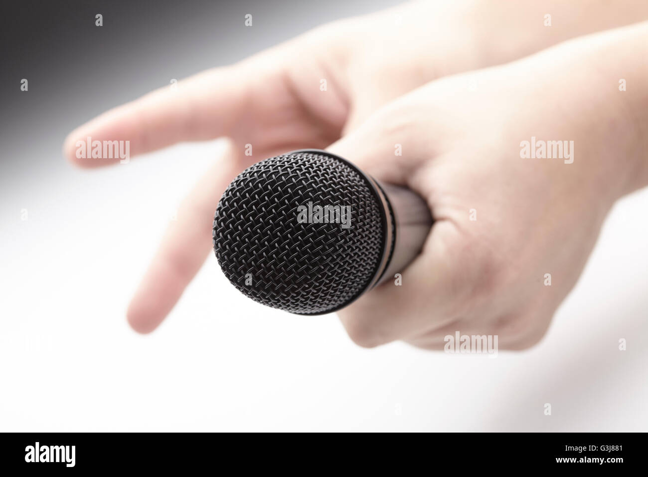 Microphone in a man's hand Stock Photo - Alamy