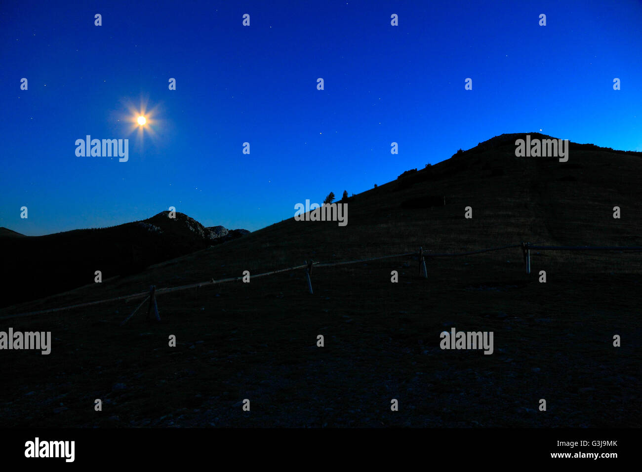 Mountain in the night with moon on the sky Stock Photo