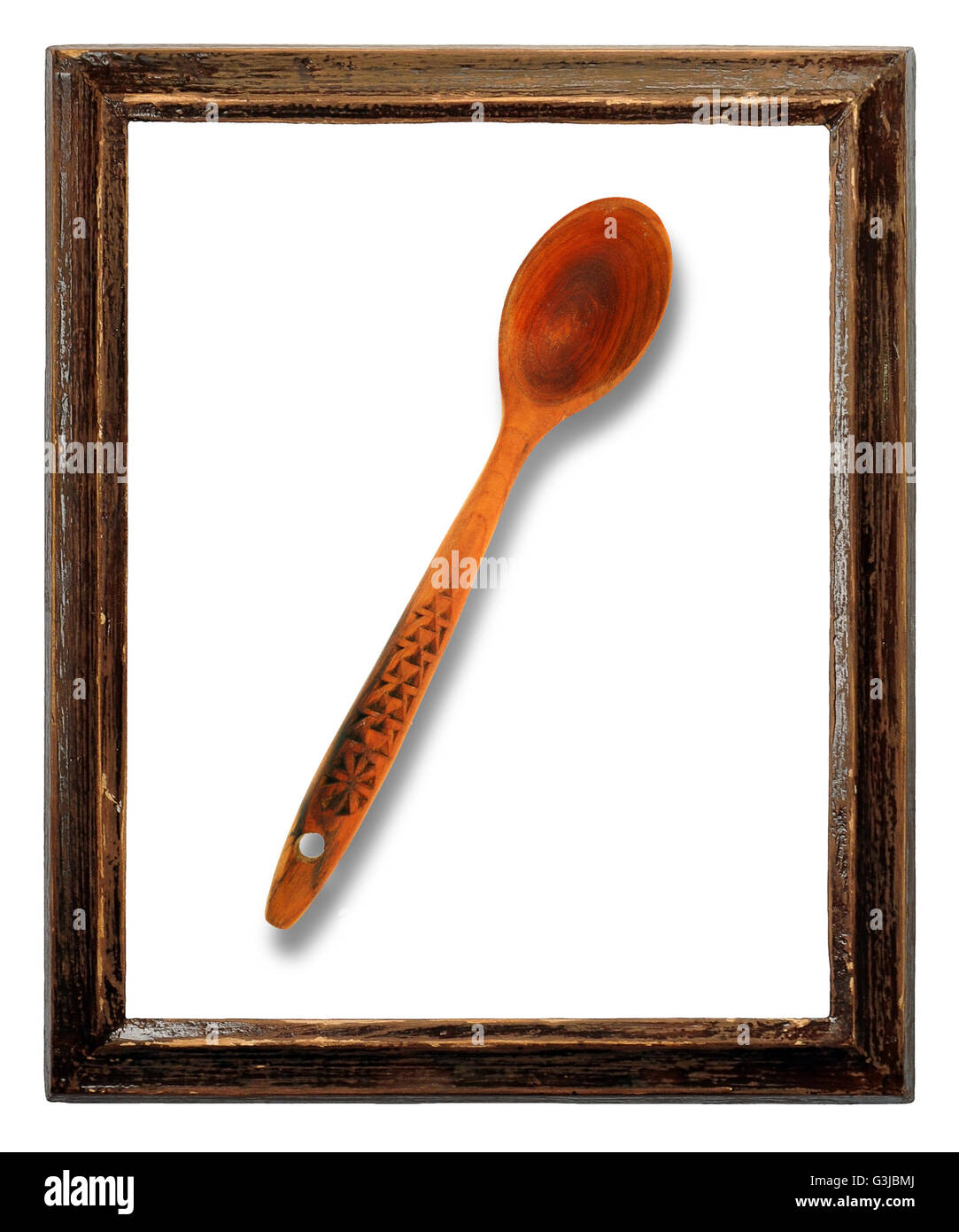 wooden spoon in old wooden frame isolated Stock Photo