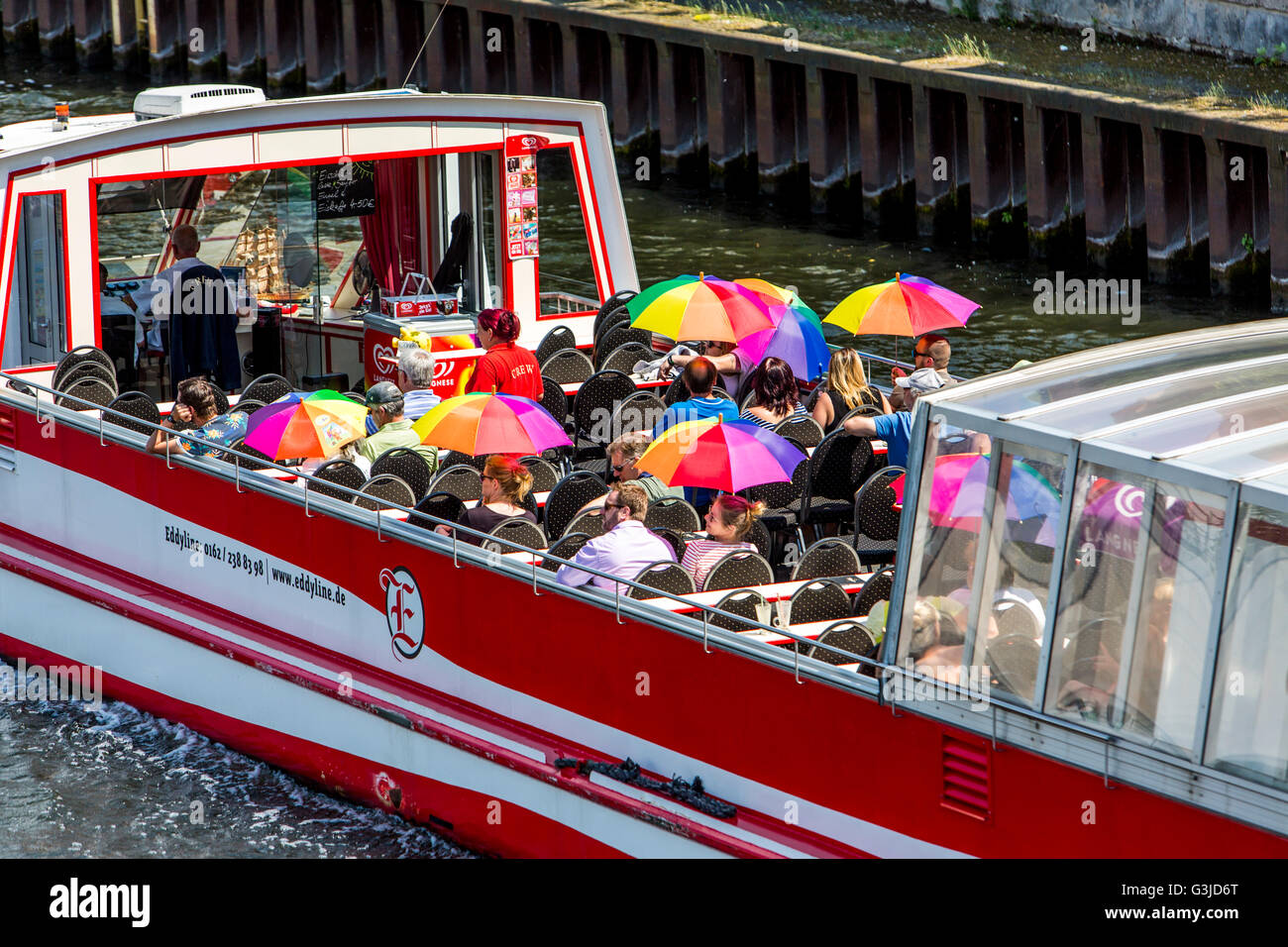Sightseeing boat on the river Spree, Berlin, Germany, tourists with colored umbrellas, Stock Photo