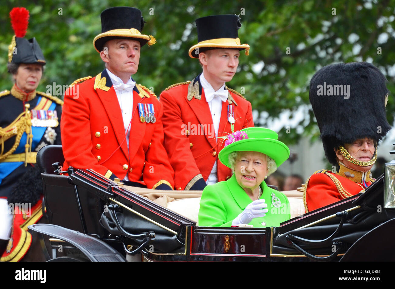 The Queen in a carriage at Trooping the Colour 2016 with Prince Philip and footmen. Green outfit. Queen Elizabth II, with Anne, Princess Royal behind Stock Photo