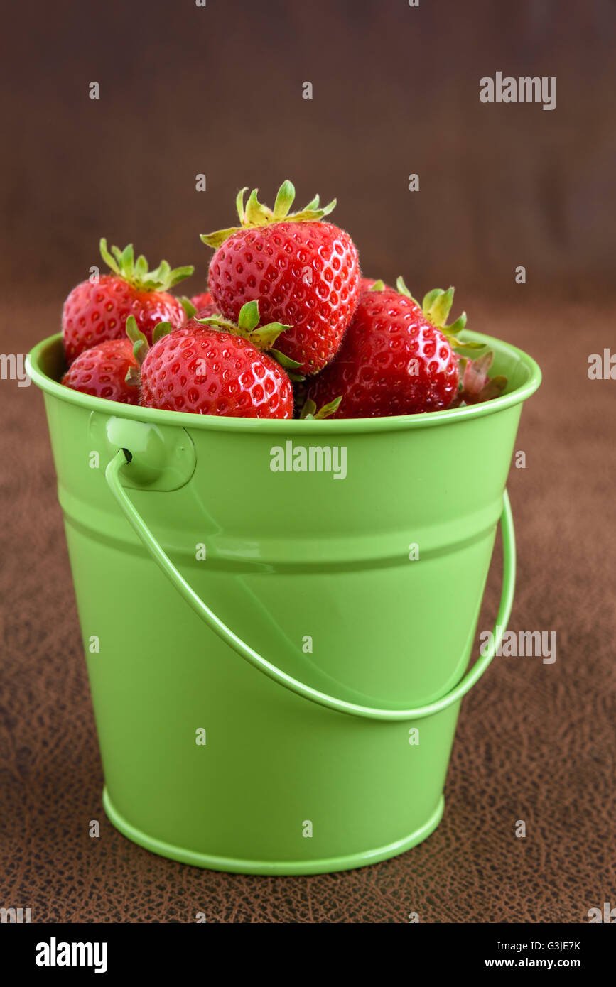 Strawberries with stems in a green bucket Stock Photo - Alamy