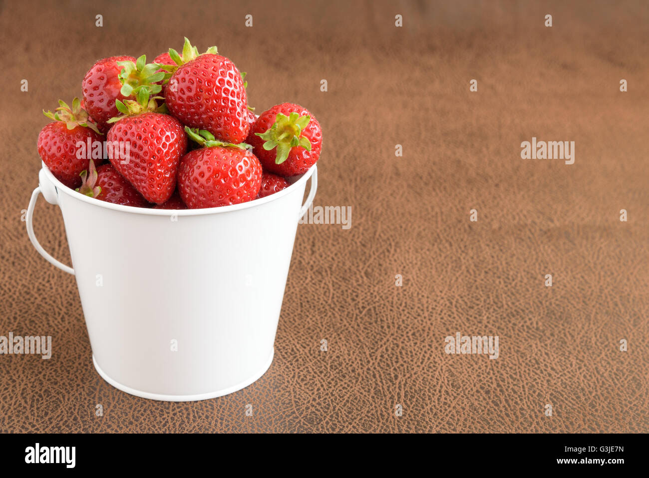 Strawberries with stems in a white bucket Stock Photo - Alamy