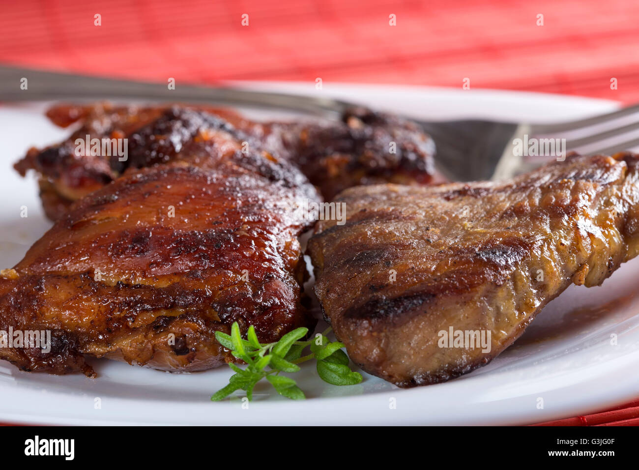 One serving of pork chop on white plate with fork Stock Photo