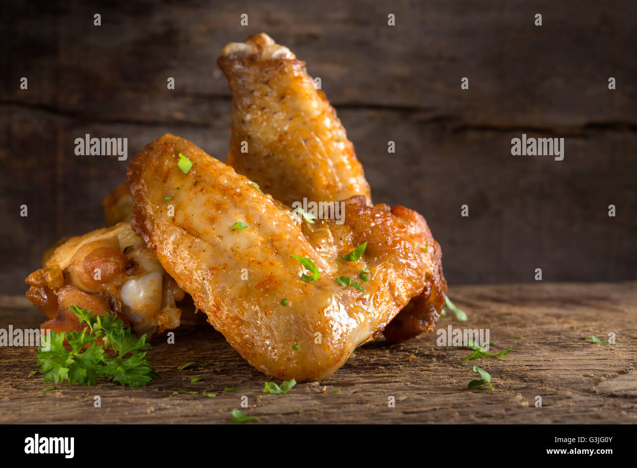 Fresh chicken minced meat on wooden background with parsley Stock Photo