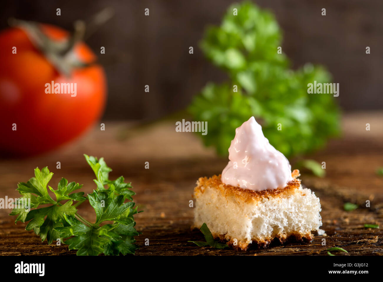 Roe salad appetizer with bread and herbs over wooden background Stock Photo