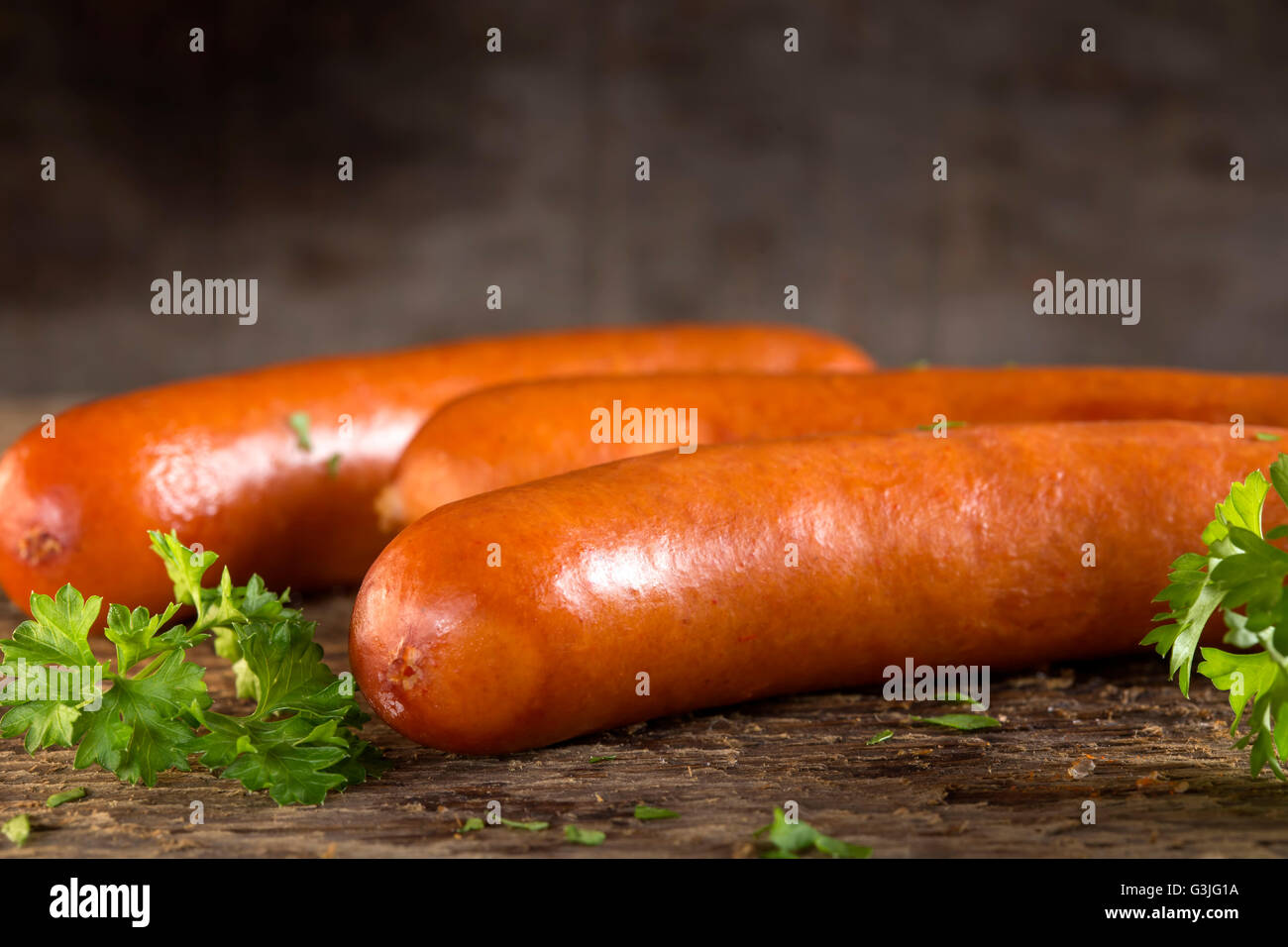 Paprika frankfurter sausage with herbs on wooden background Stock Photo
