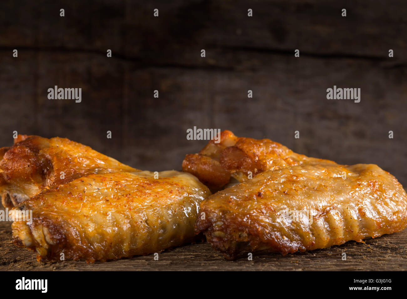 Two fried chicken wings on wood board Stock Photo