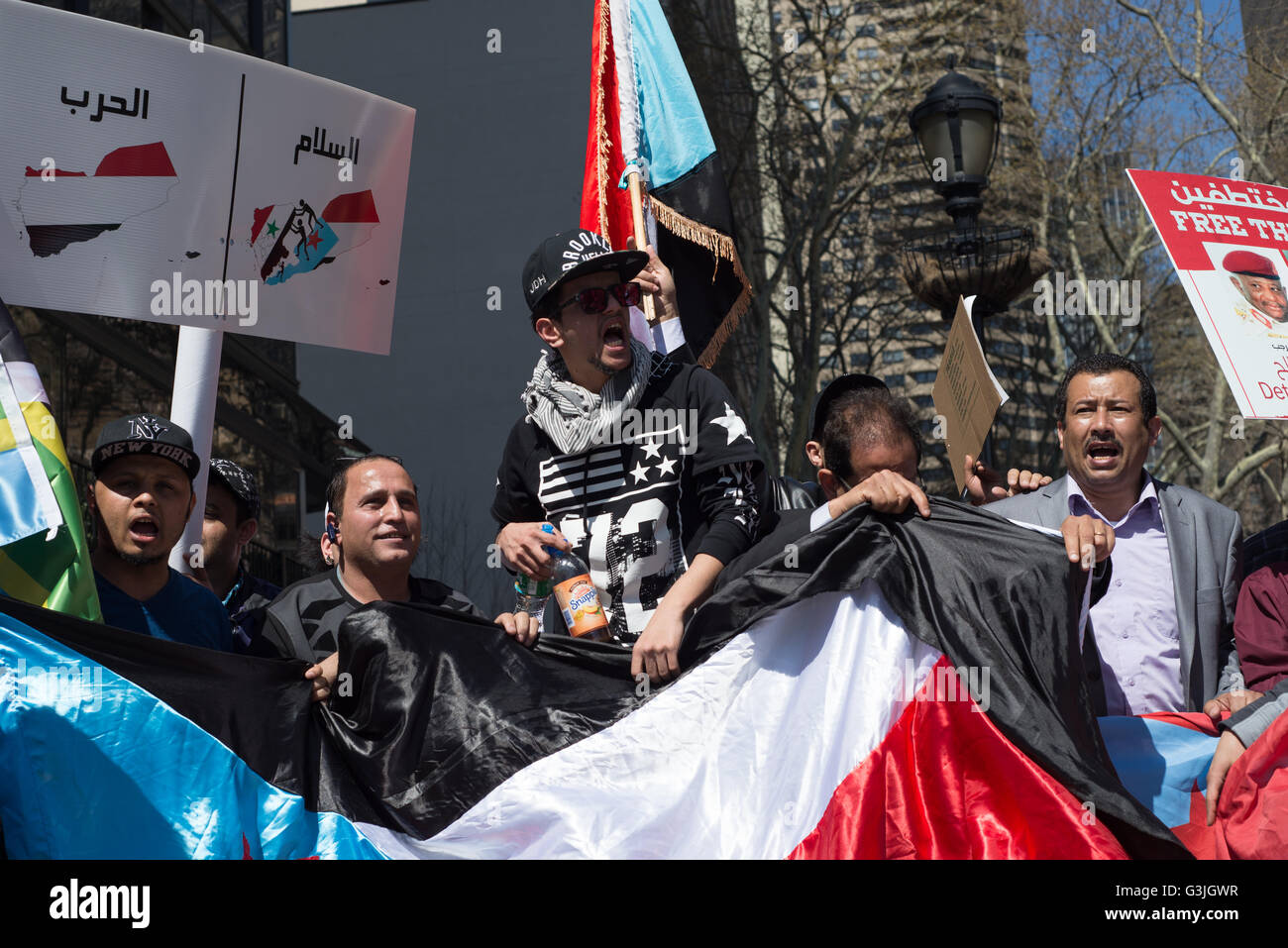 New York, United States. 18th Apr, 2016. Demonstrators wave flags and chant while participating in the rally. Amid the delay of United Nations-brokered peace talks between ex-Yemeni President Ali Abdullah Saleh and Houthi representatives due to have begun in Kuwait, and continued military engagement of Houthi-forces by a Saudi-led coalition; demonstrators gathered in Dag Hammarskjold Plaza near UN HQ in New York City to demand restoration of independence for South Yemen in solidarity with similar protests in Aden, Yemen over the past two days. © Albin Lohr-Jones/Pacific Press/Alamy Live News Stock Photo