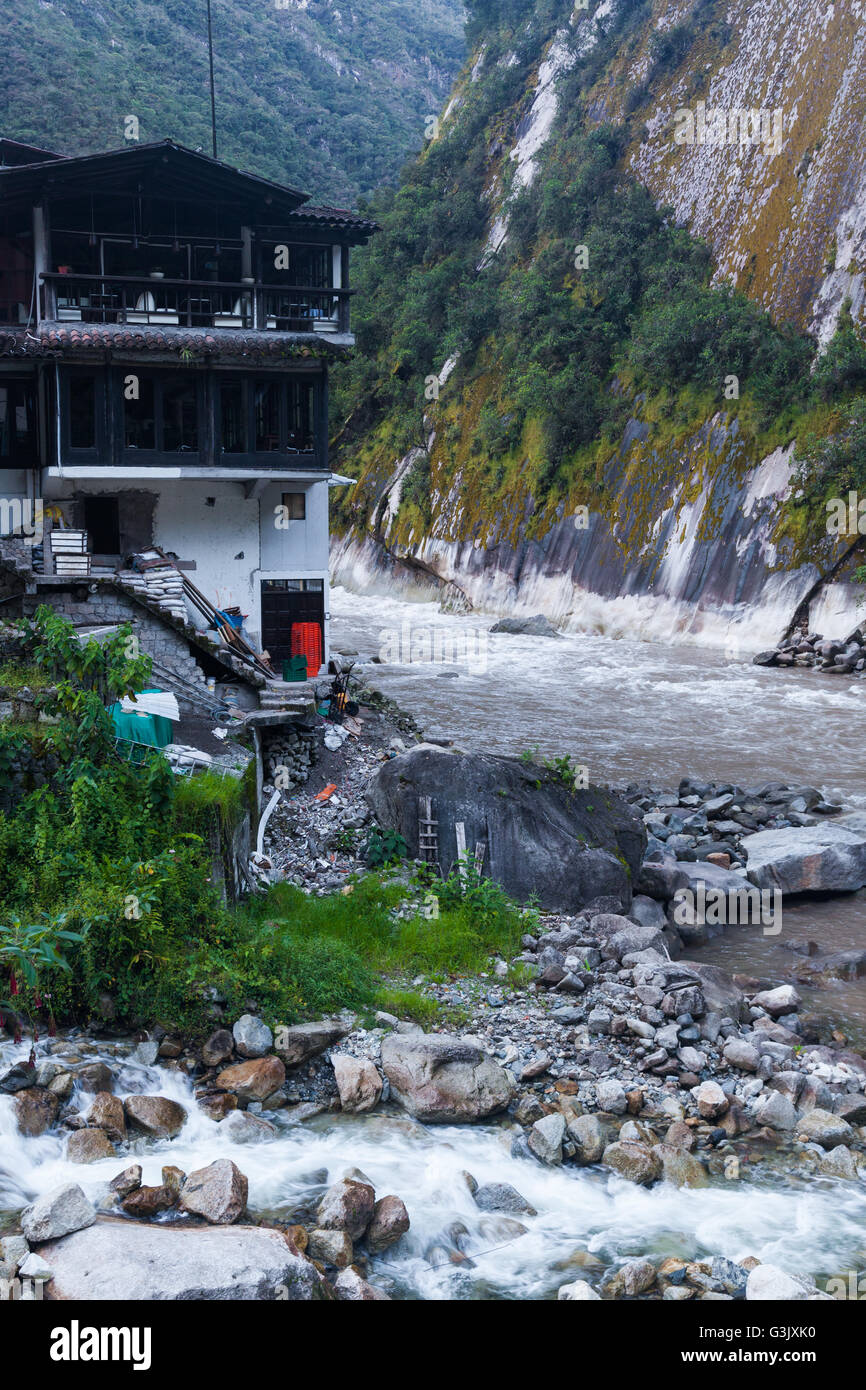 Confluence of a small tributary stream with the Urubamba River in Aguas Calientes, Peru Stock Photo
