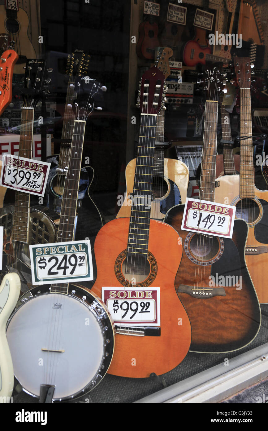 guitars displaying in the window of a musical instrument store in Old Montreal. Quebec Canada Stock Photo