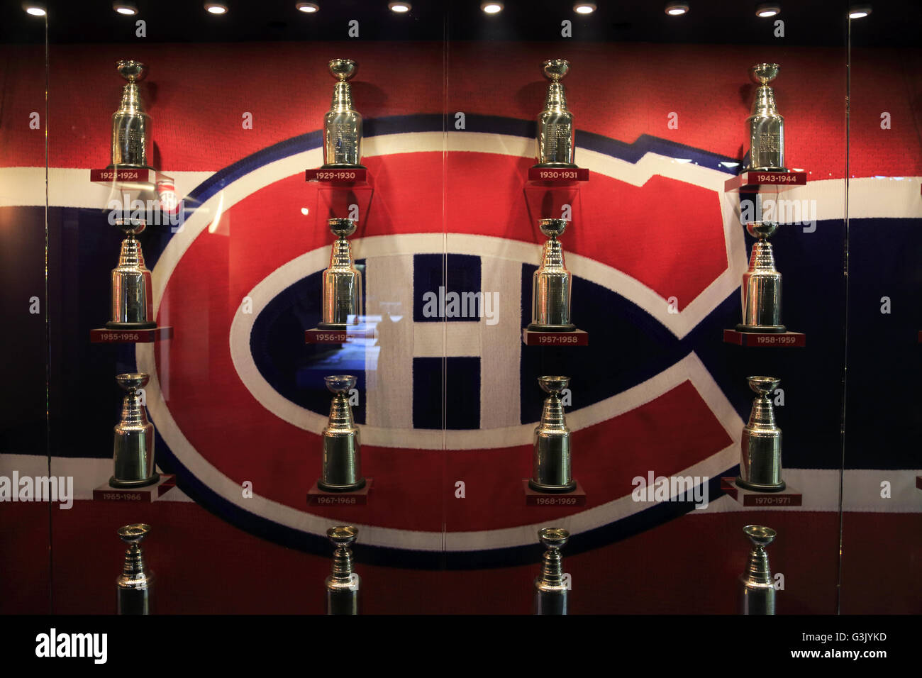 Trophy cups display in front of the logo of NHL Montreal Canadiens in