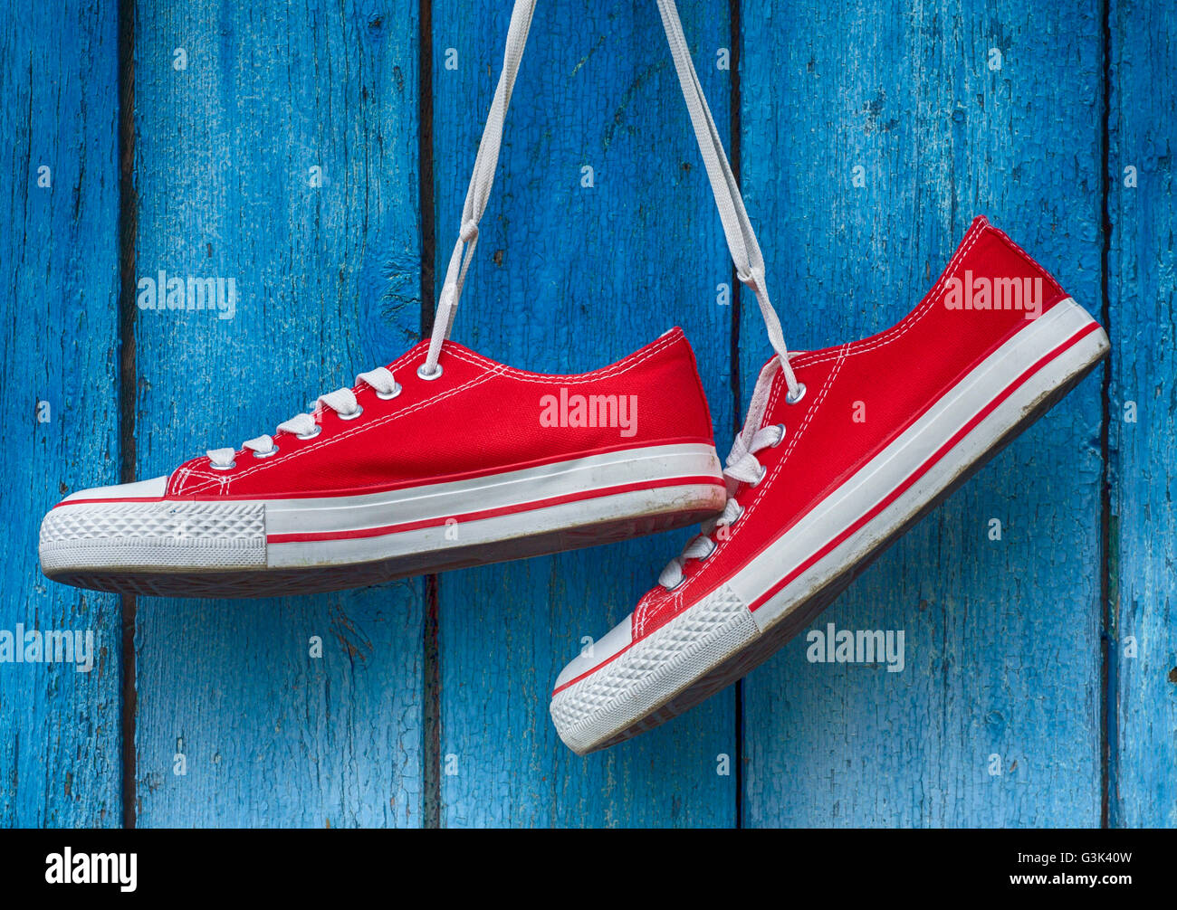 Old trainers hanging by laces hi-res stock photography and images - Alamy