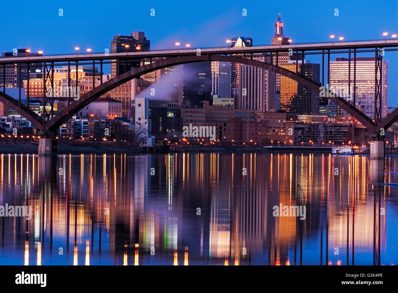 Saint Paul, Minnesota skyline and reflection at dusk with the Smith Ave High Bridge in the foreground. Stock Photo
