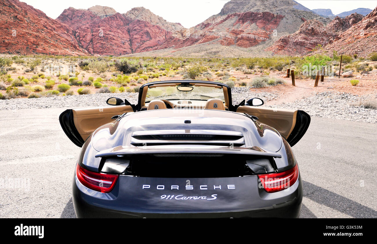 Rear view of a Porsche 911 Carrera S with doors open on a desert mountain  road Stock Photo - Alamy
