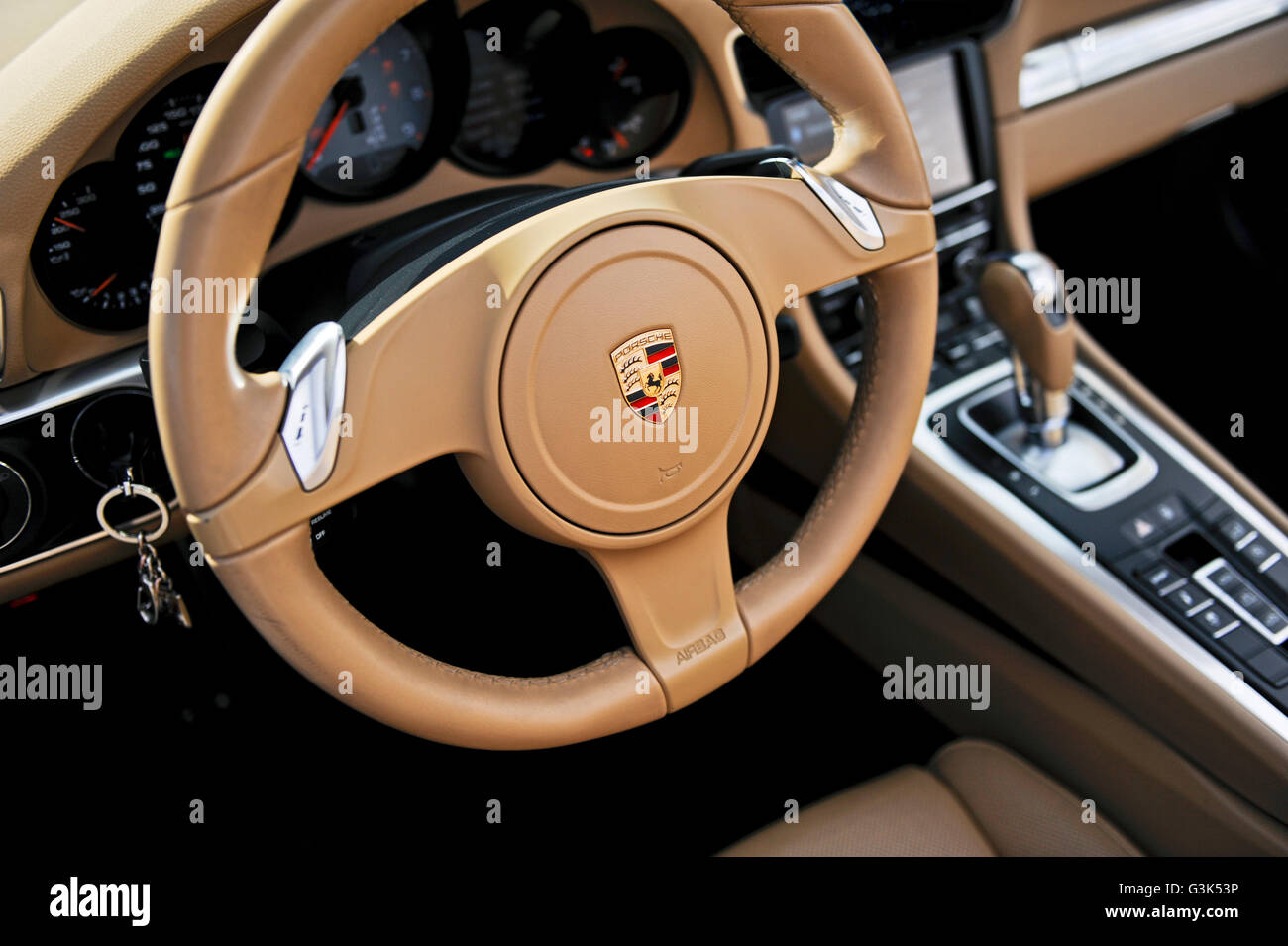 The interior dashboard, steering wheel and console of a Porsche 911 Carrera S Stock Photo