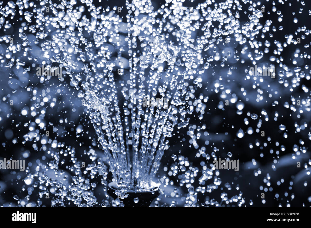 Water fountain. Monochrome image toned in blue Stock Photo