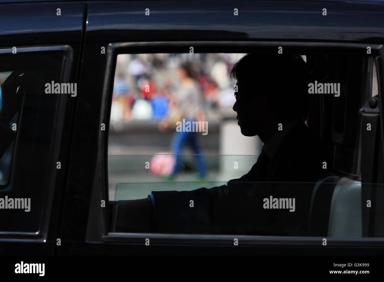 Silhouette of a male looking out of a taxi window in Trafalgar Square, London, England. Stock Photo