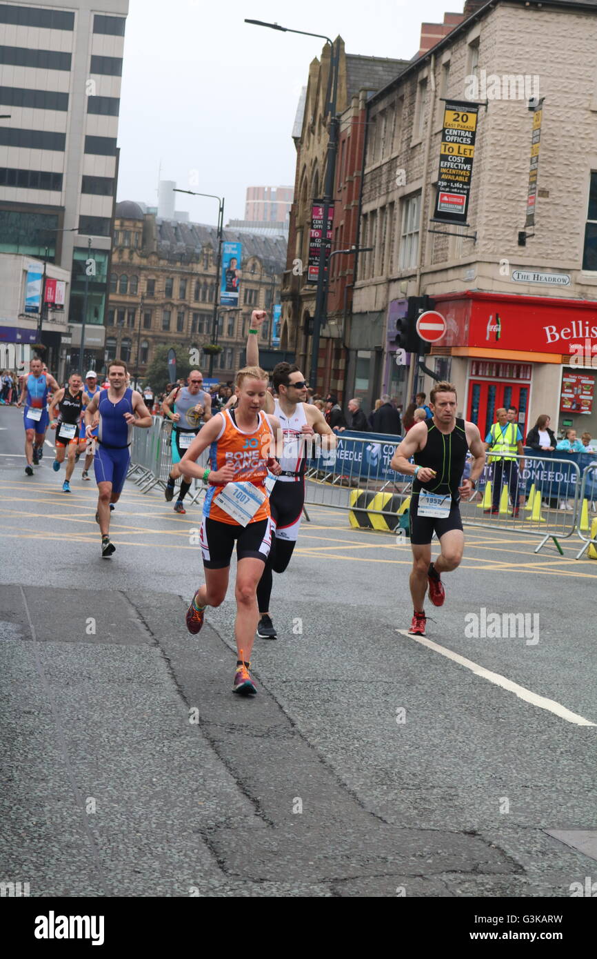 Competitors in the open race category at World Series Triathlon in Leeds run through the city centre. Stock Photo