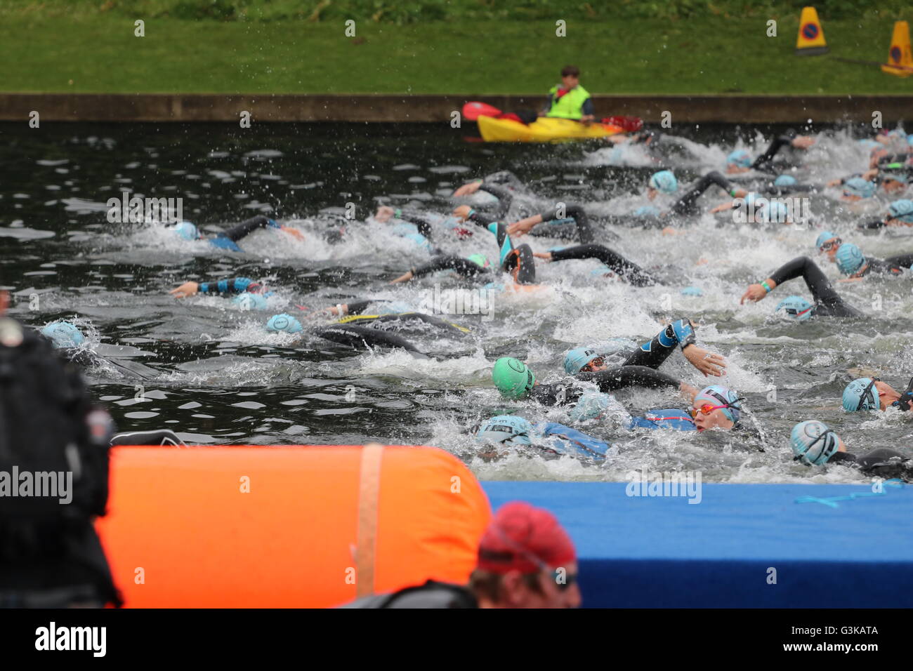 Triathletes start a swim wave in Roundhay Park Lake during the open race category at World Series Triathlon, Leeds. Stock Photo