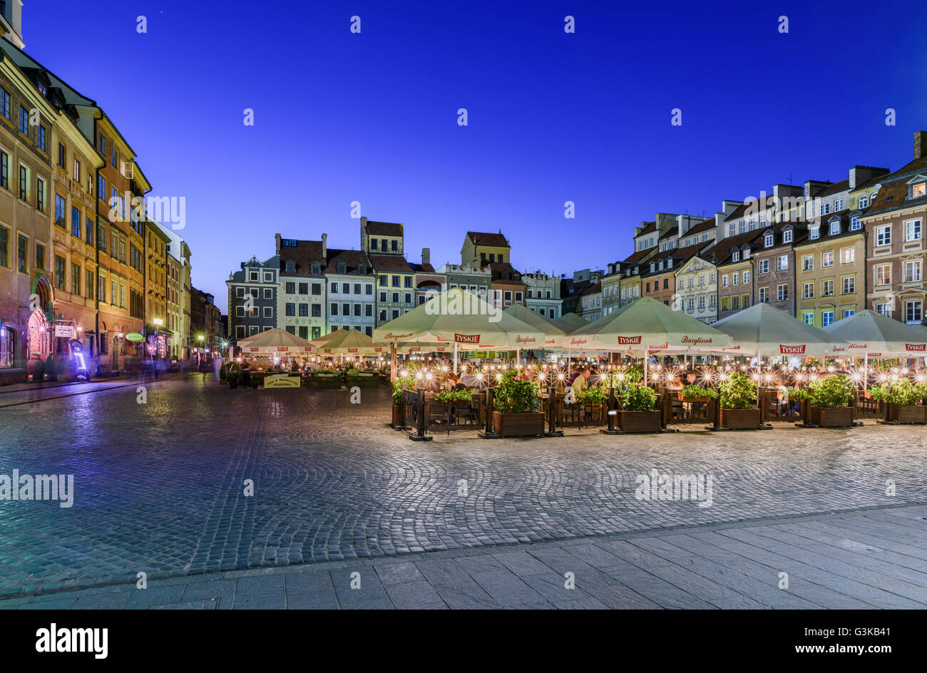 Busy pavement restaurants in Warsaw Old Town Square Stock Photo