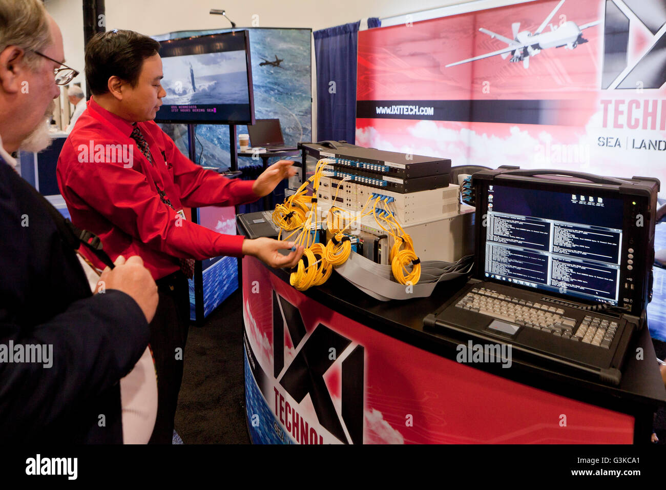 Technician demonstrating military use communications servers at an expo - USA Stock Photo