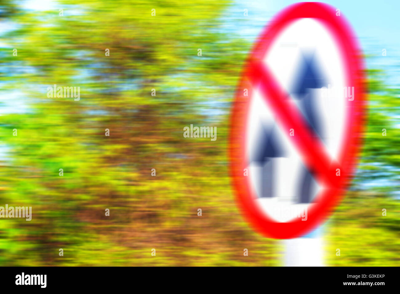 Traffic signs and trees along the road with blurred images. Stock Photo