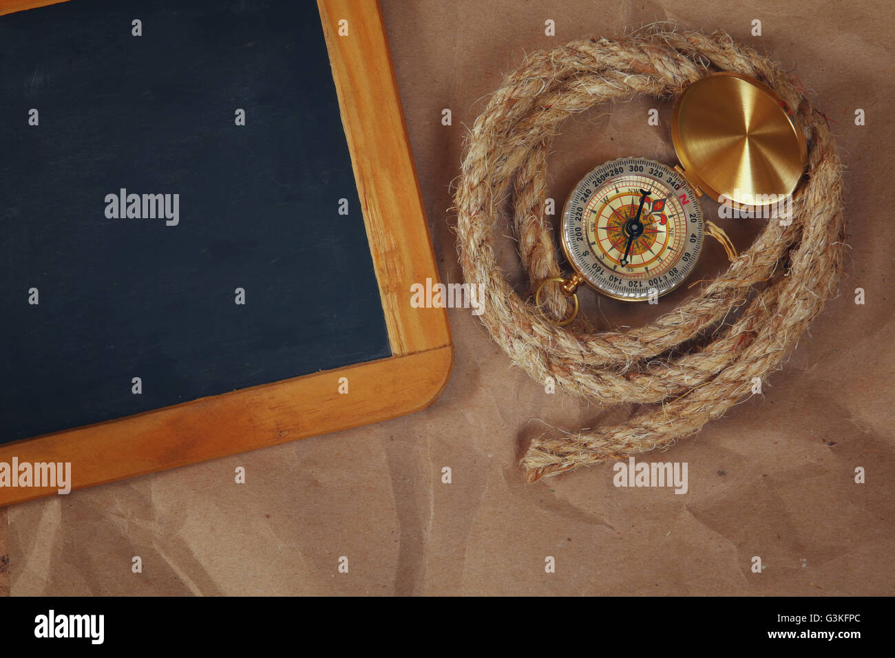 top view of compass, rope and blank blackboard. explorer and adventure ...