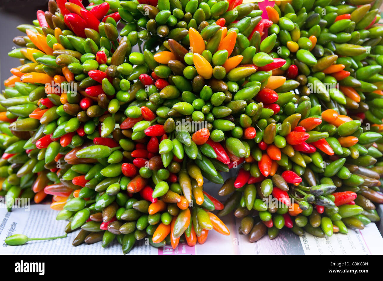 Bunch of green and red peppers chili at market Stock Photo