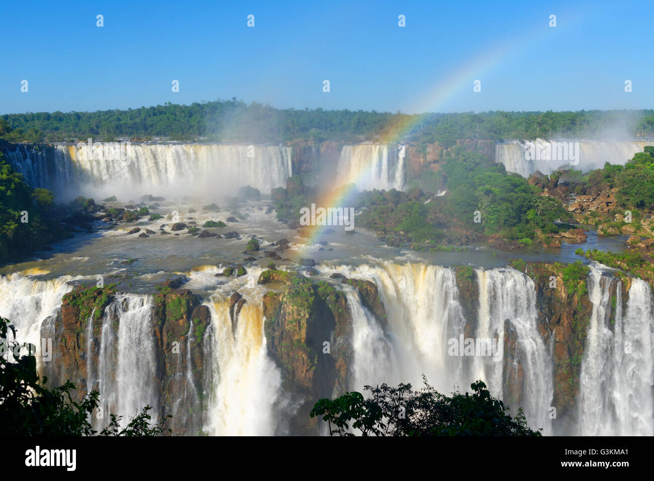 Rainbow arching over Iguacu Falls, between Brazil and Argentina waterfall Stock Photo