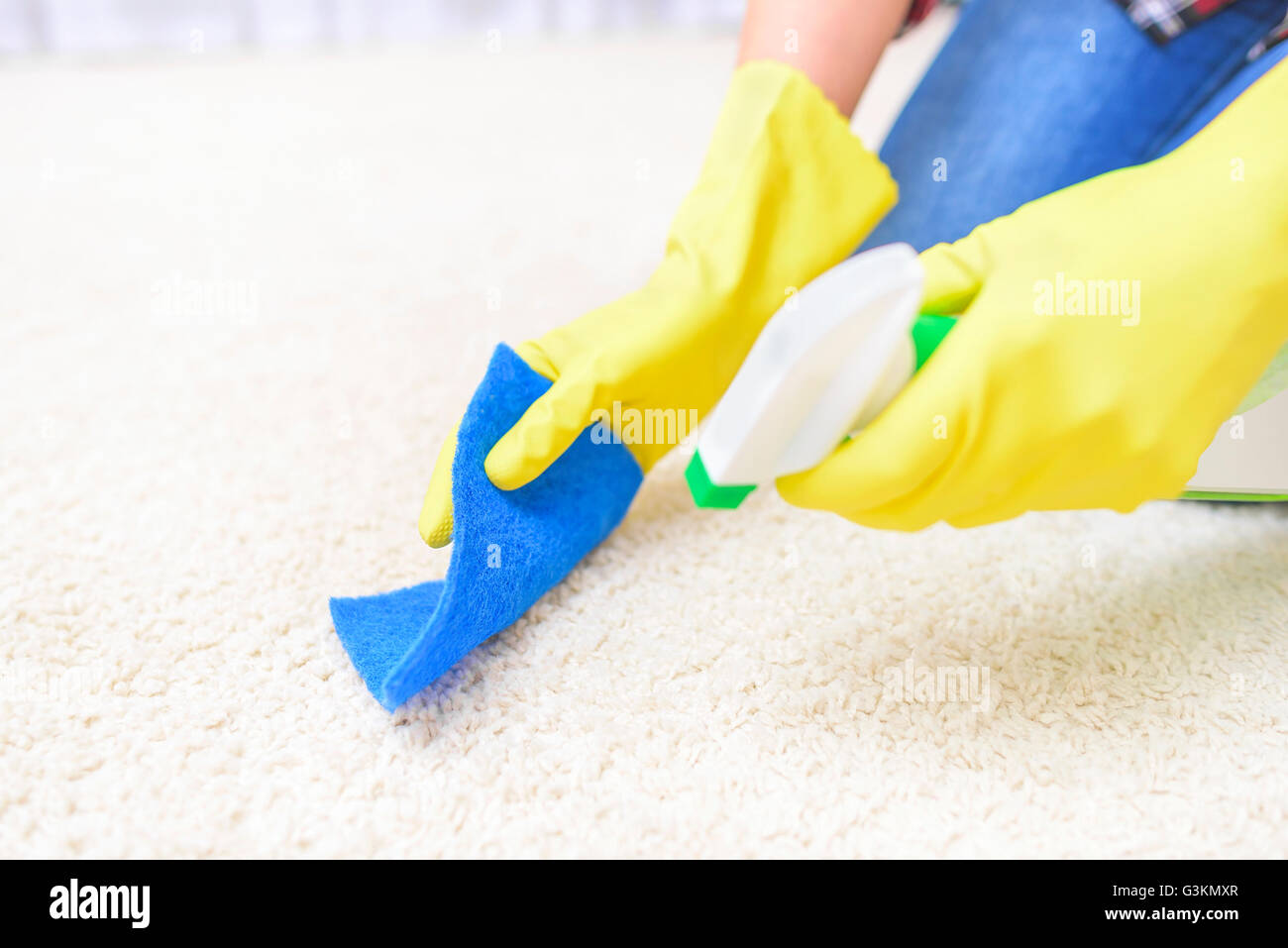 Carpet Cleaning spray. Close-up. Focus on a washcloth and carpet. Stock Photo