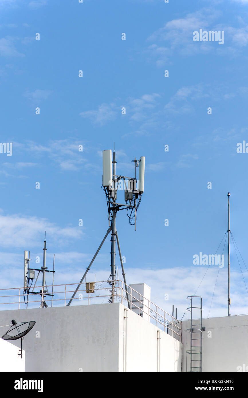 panel antenna mobile communication on background blue sky. telecommunications antenna tripod on the tower. Stock Photo