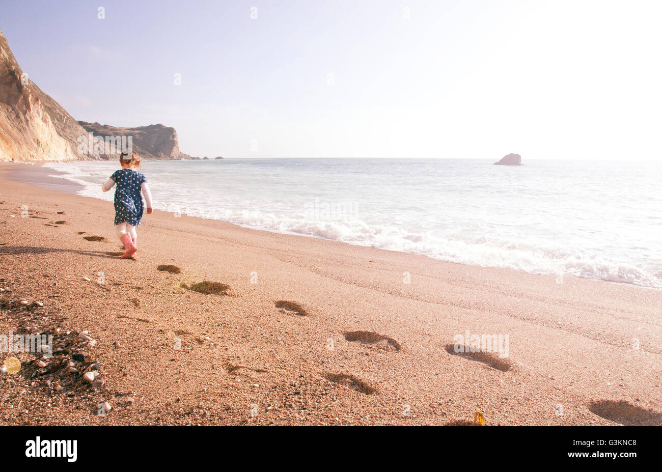 Girl enjoying beach, Man O'War Beach, Dorset Stock Photo