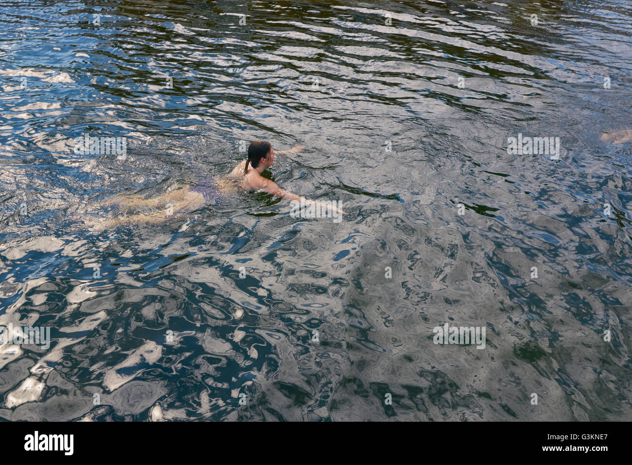 Young woman swimming in sea, elevated view Stock Photo
