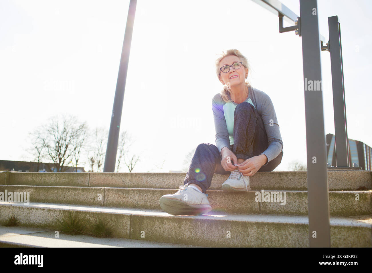 Fitness woman sitting on steps hi-res stock photography and images - Alamy