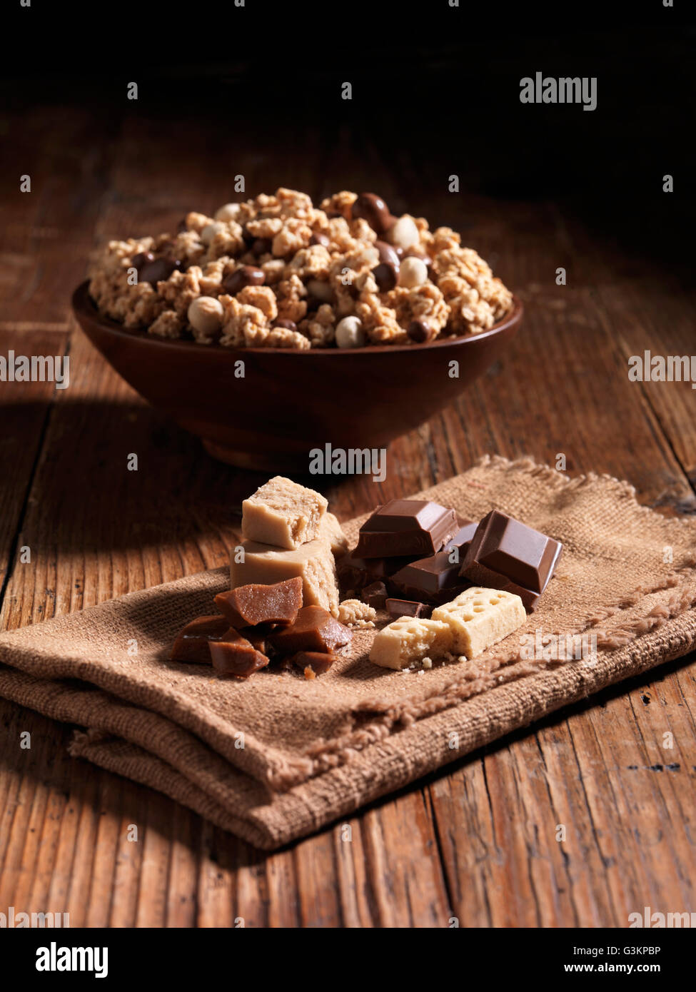 Millionaires caramel crunch in bowl with ingredients beside it Stock Photo