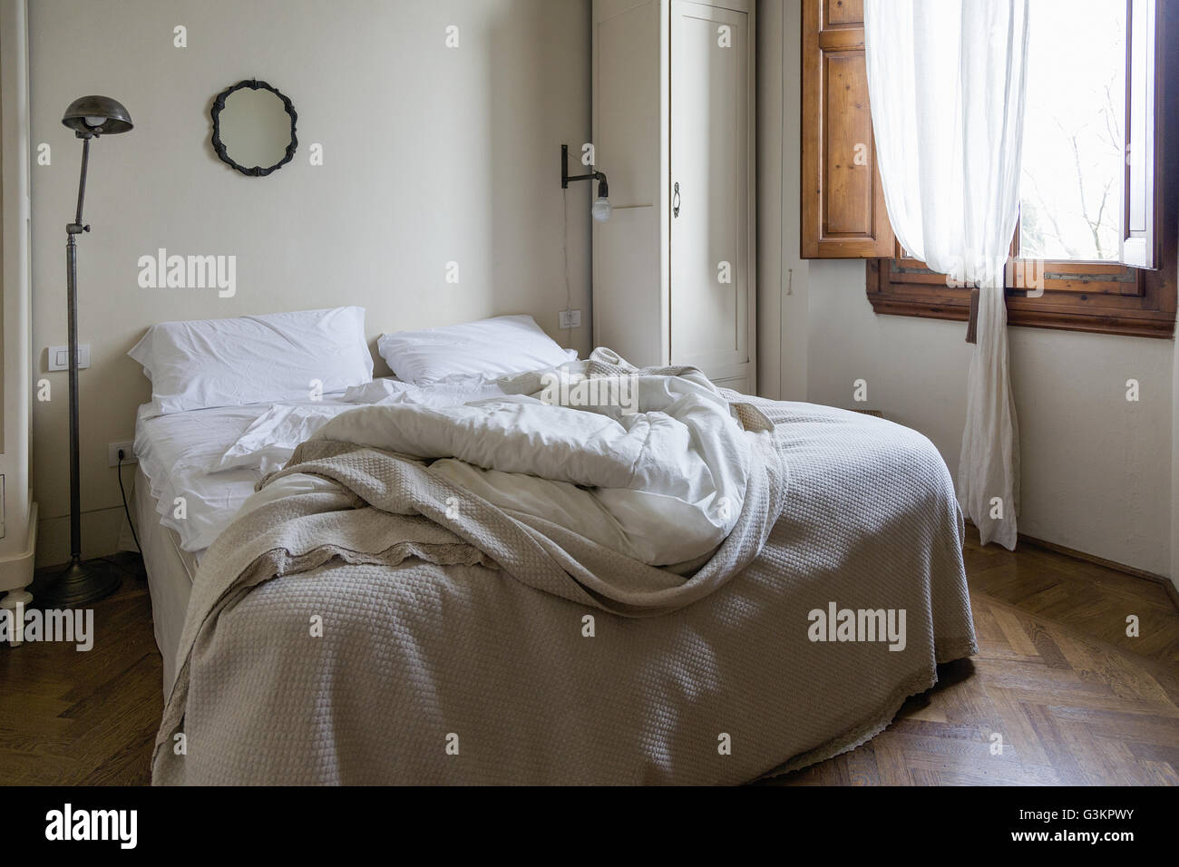 Unmade double bed Stock Photo