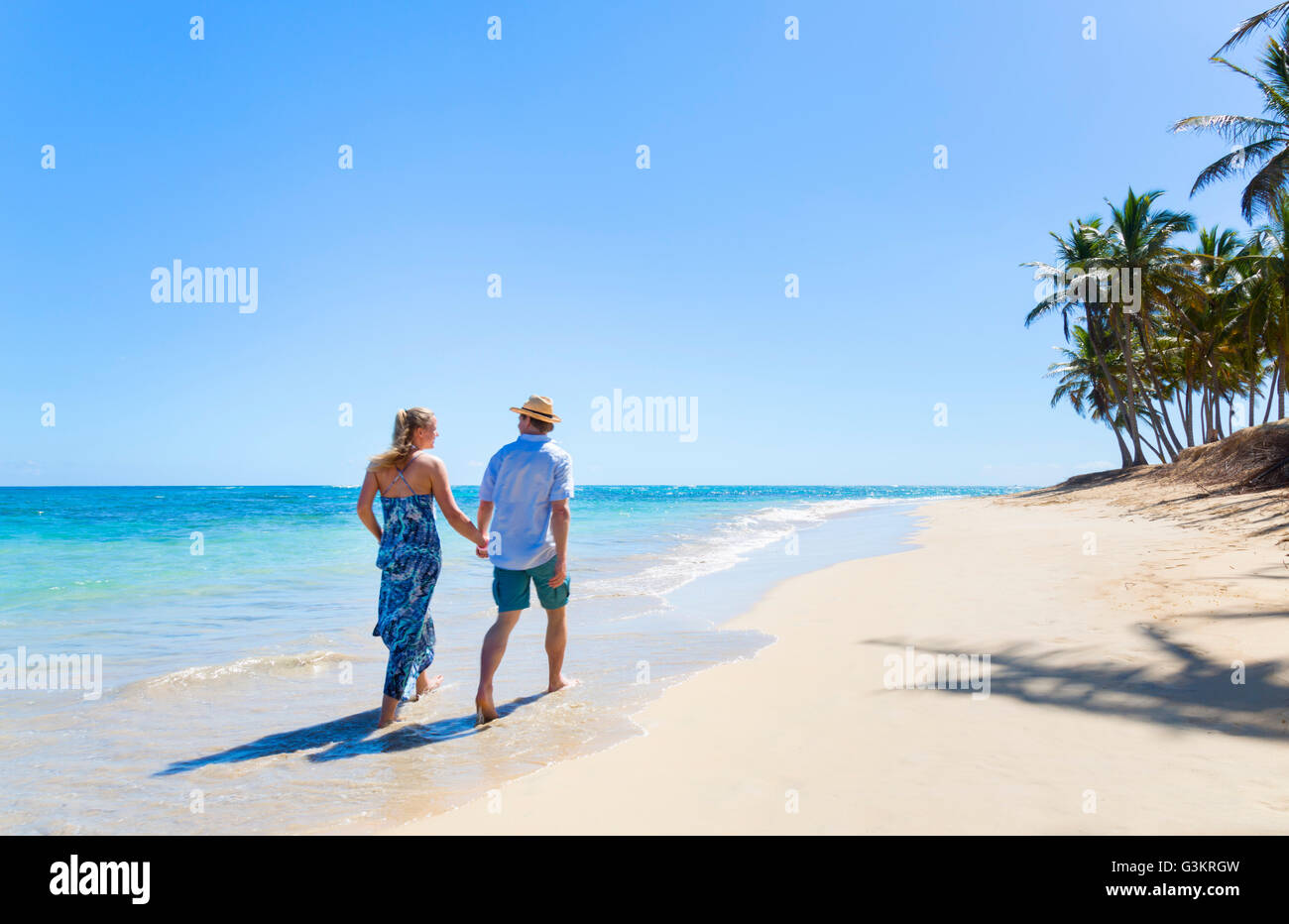 Rear view of mature couple strolling along beach, Dominican Republic, The Caribbean Stock Photo